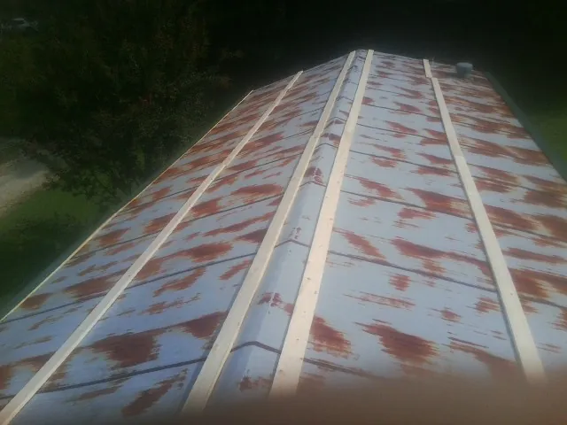 Rusted metal roof panels with new wood purlins before replacement — Storm Damage Roof Repair in Vina by Roofing Brothers
